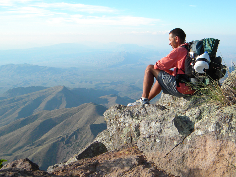  The author sits on a rock ledge of the South Rim of Big Bend's Chisos Mountain Range.